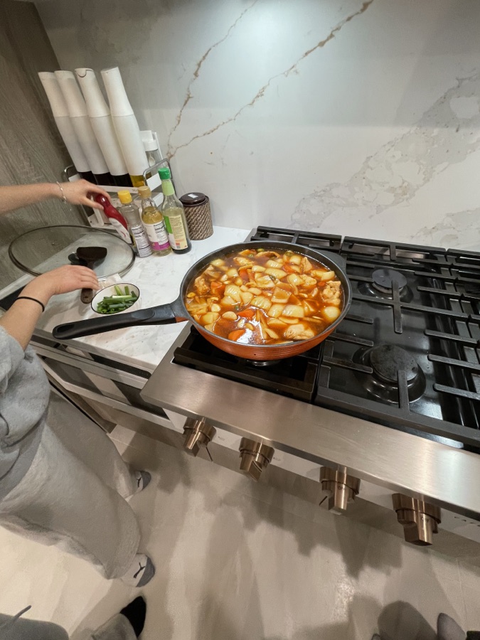Tteokbokki simmering in a pan on the stove